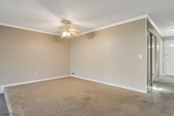 an empty room with windows and fireplace