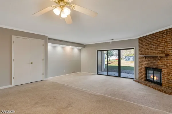 wooden floor fireplace and natural light in room