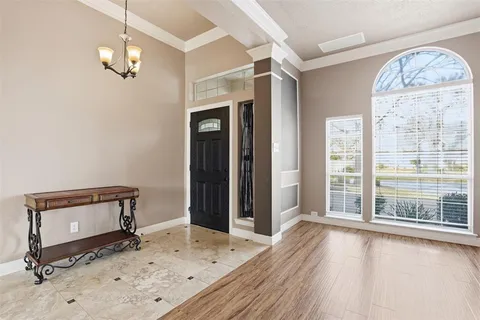 a view of a livingroom with wooden floor and a window