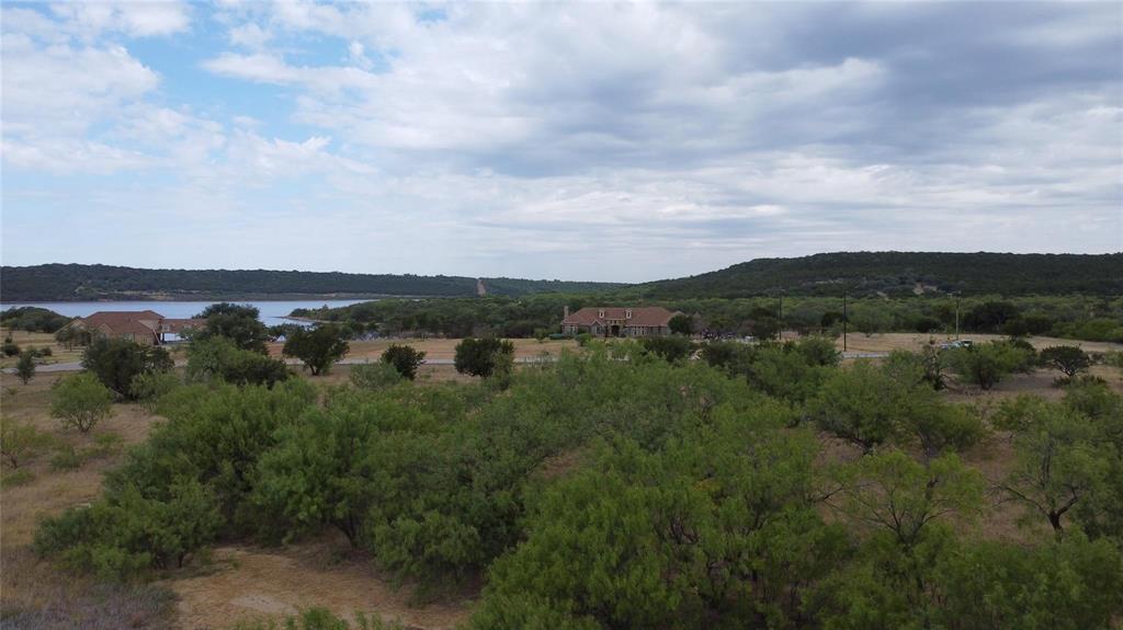 Lot 1049 Frog Branch Graford, TX 76449 - Photo 7 of 14 an aerial view of a city with lots of residential buildings and mountain view in back