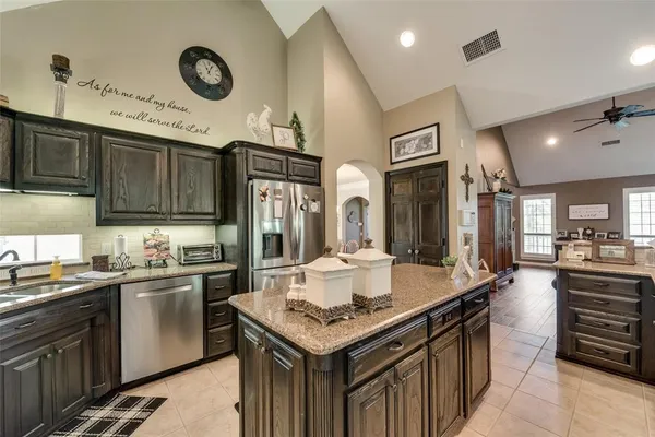 a dining hall with stainless steel appliances granite countertop a granite counter tops and a view of living room