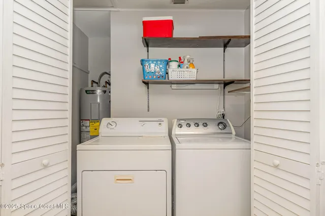 a bedroom with two beds and a flat screen tv