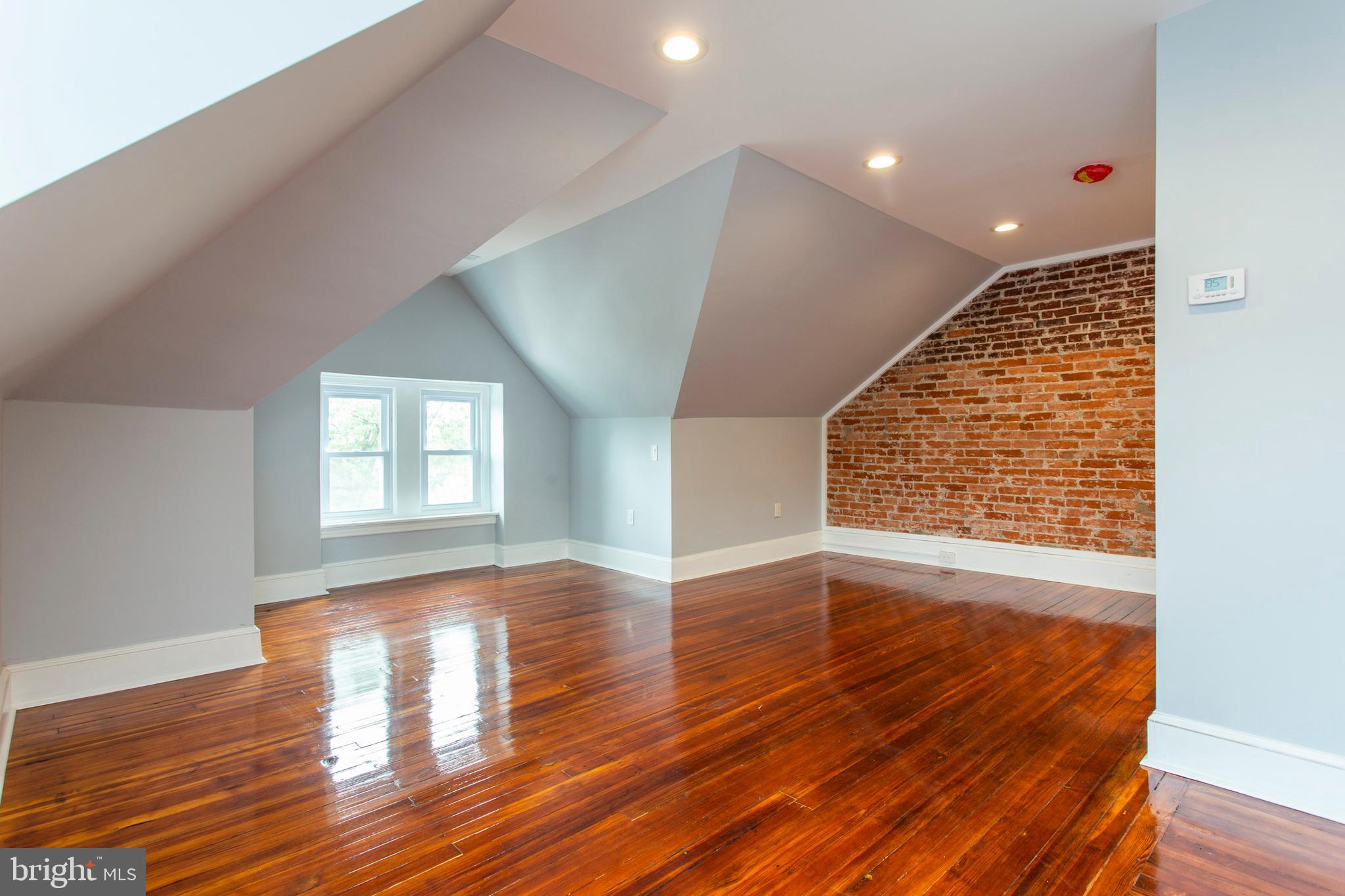 6127 Nassau Road Philadelphia, PA 19151 - Photo 33 of 39 Master bedroom with exposed brick