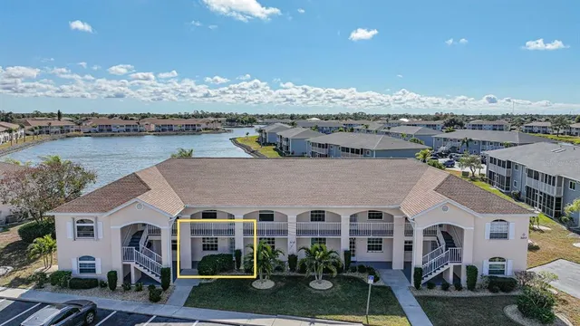 a front view of a house with a yard and balcony