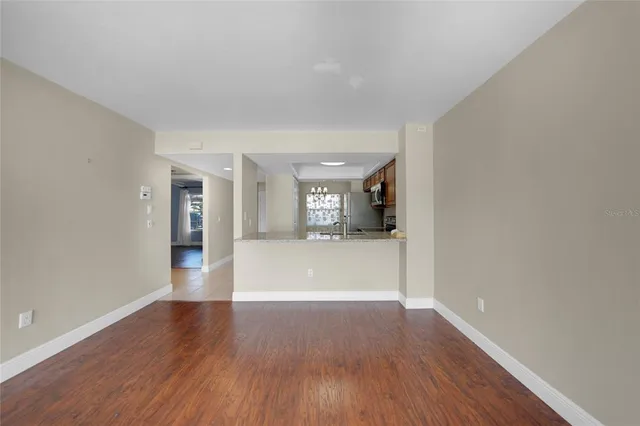 a view of empty room with wooden floor and fireplace