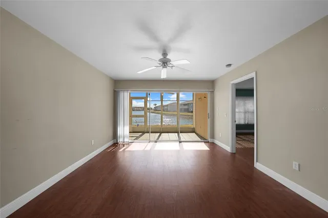 an empty room with wooden floor and a window