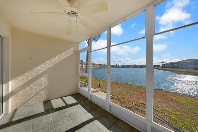 a view of a glass door with a ocean from a window