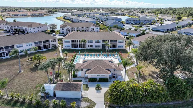 an aerial view of a house with a garden and lake view