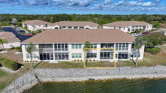 an aerial view of a house with swimming pool and a yard