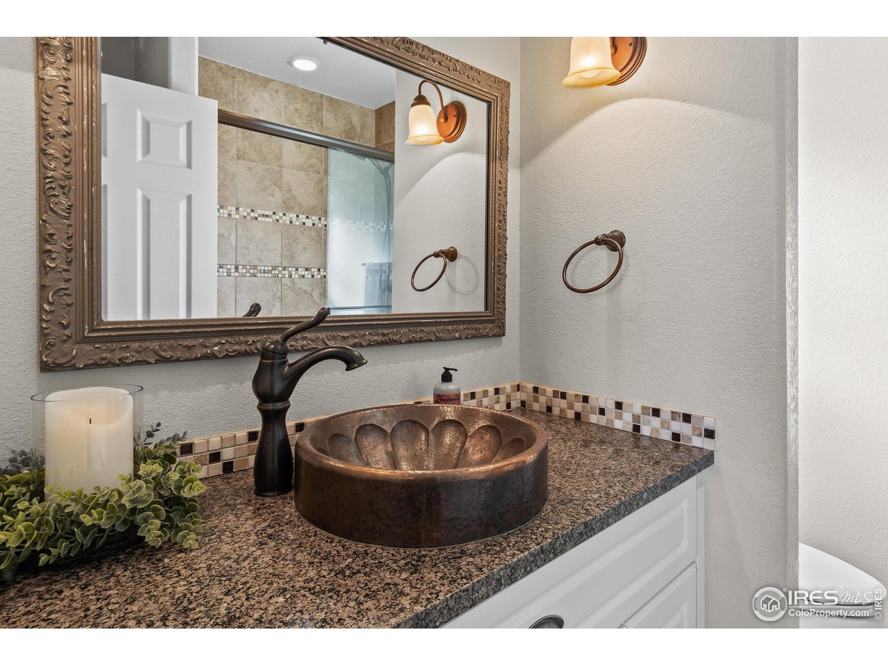 2002 Trail Ridge Drive Severance, CO 80615 - Photo 15 of 38 a bathroom with a sink and a mirror