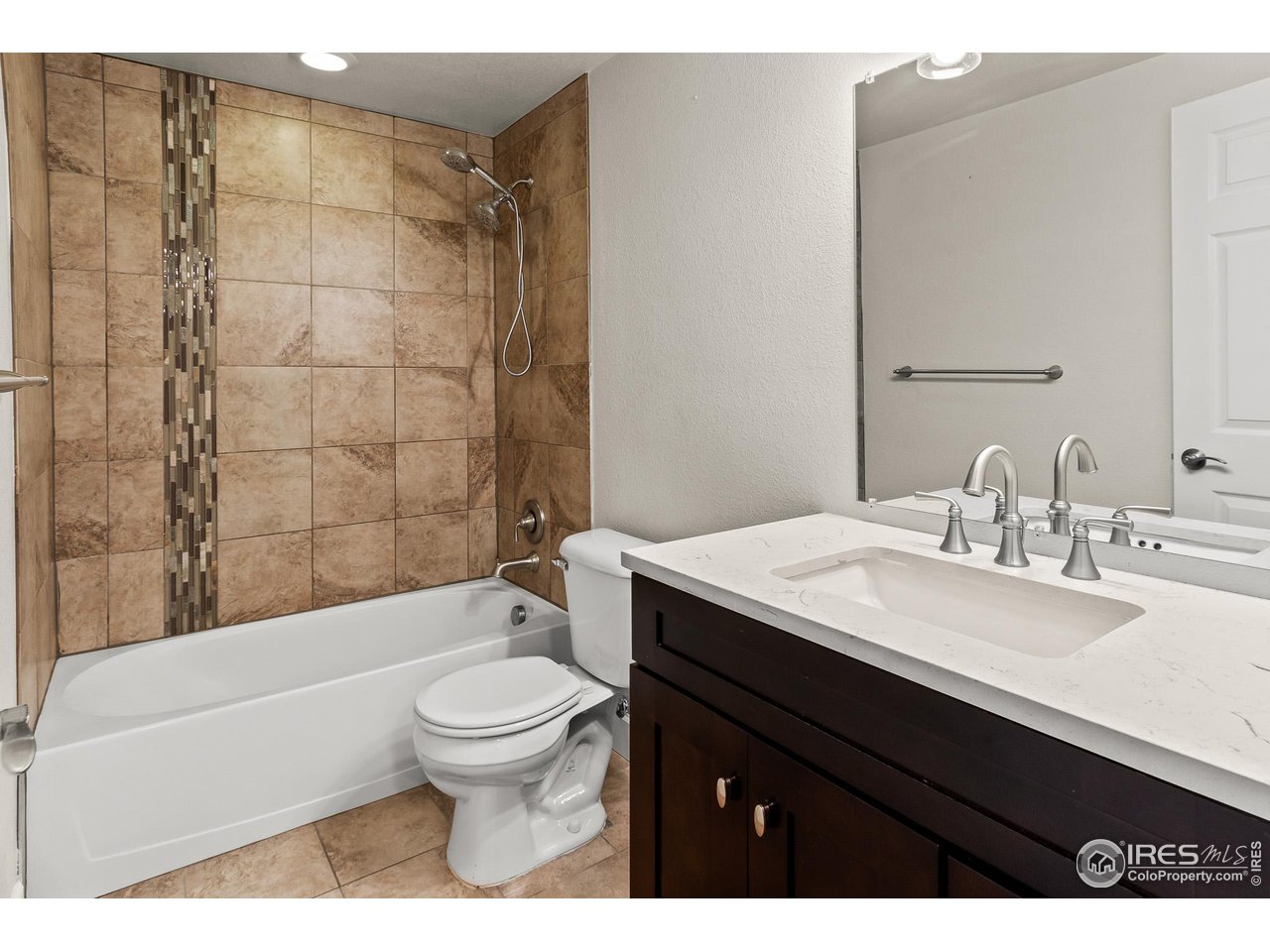 2002 Trail Ridge Drive Severance, CO 80615 - Photo 16 of 38 a bathroom with a sink a toilet and a mirror