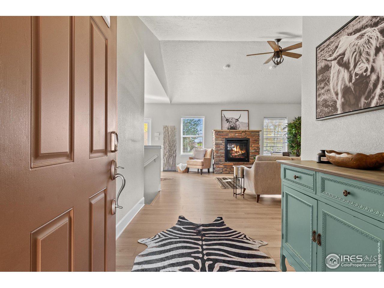 2002 Trail Ridge Drive Severance, CO 80615 - Photo 6 of 38 a living room with furniture a fireplace and a flat screen tv