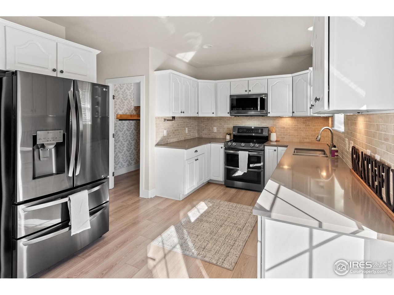 2002 Trail Ridge Drive Severance, CO 80615 - Photo 10 of 38 a kitchen with stainless steel appliances granite countertop a refrigerator a stove and a sink