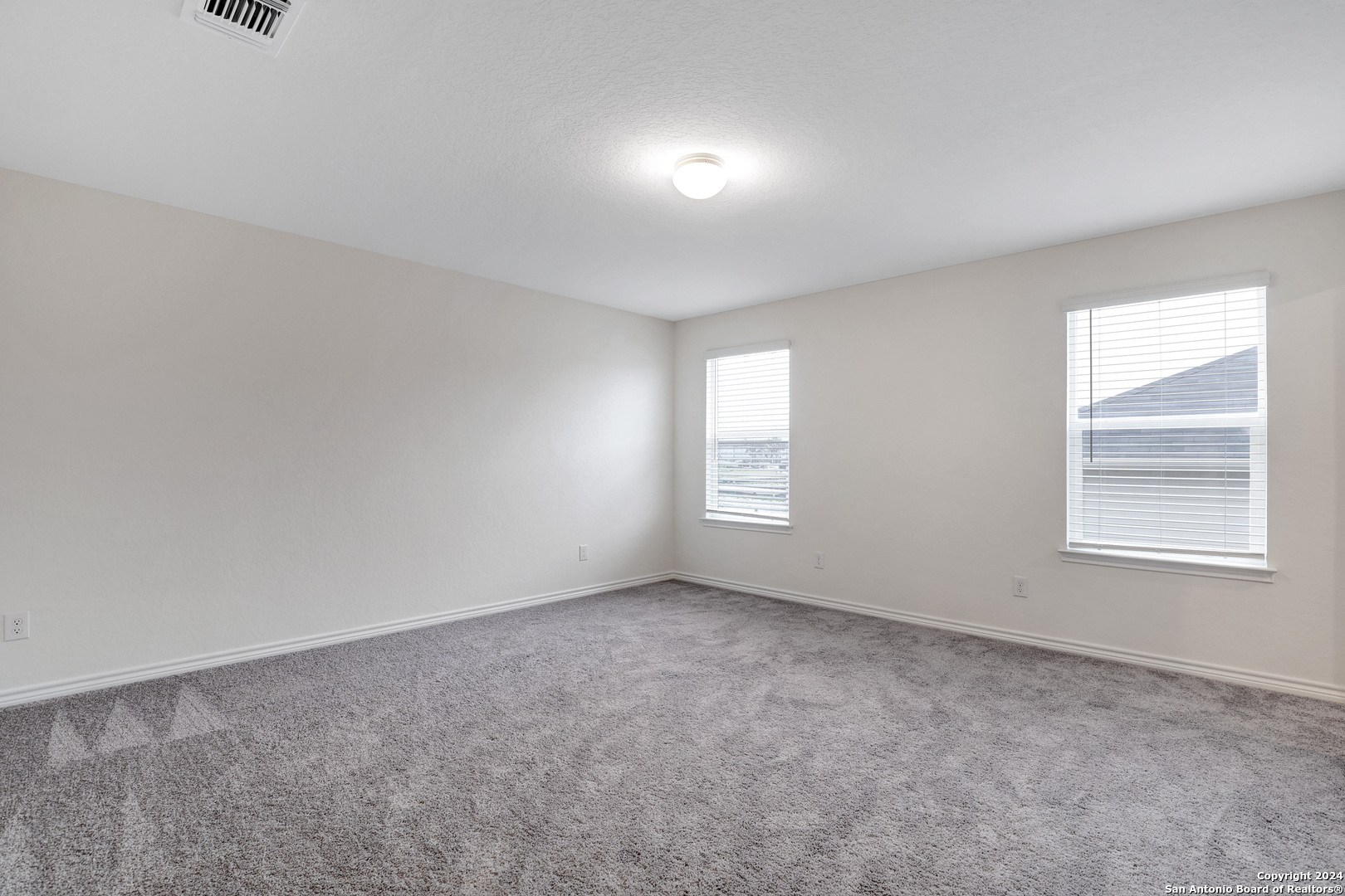 14839 Vance Jackson Road, Unit 416 San Antonio, TX 78249 - Photo 2 of 5 an empty room with windows