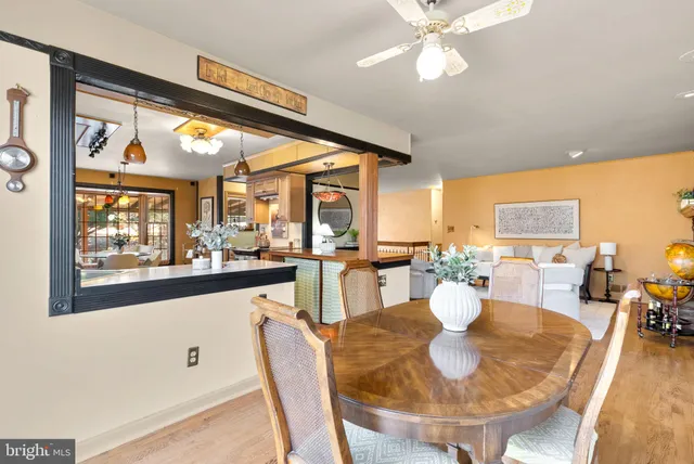 a view of a dining room with furniture large windows and wooden floor