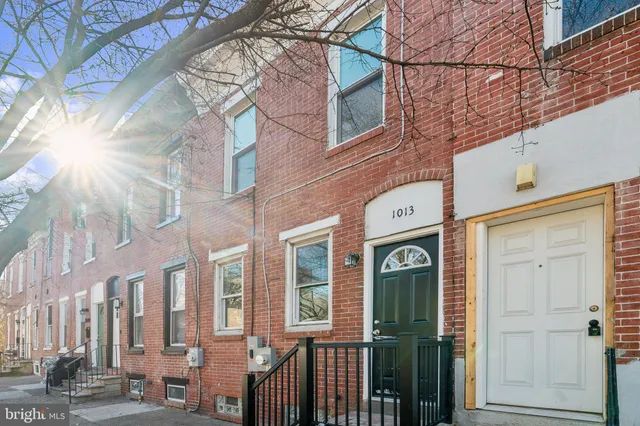 a front view of a brick building with many windows