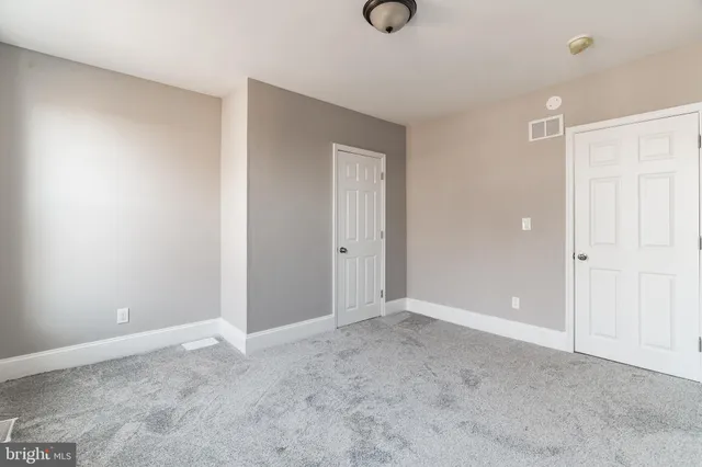 a view of an empty room and closet area
