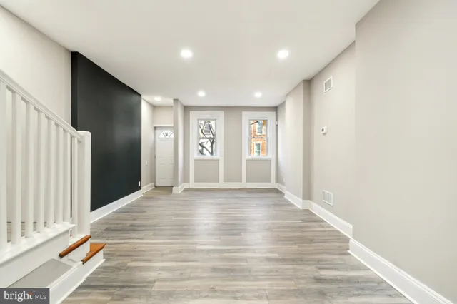 a view of an empty room with wooden floor