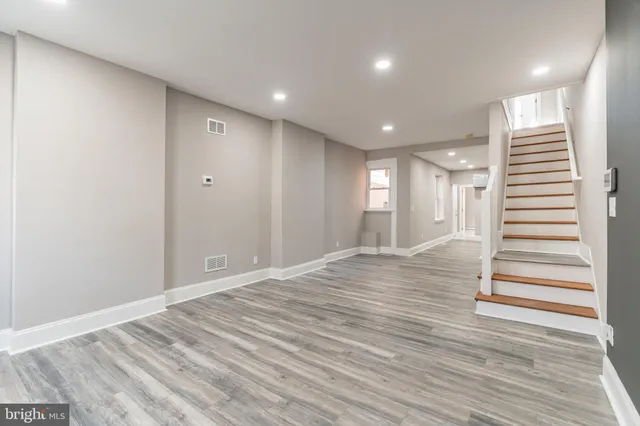a view of a hallway with wooden floor