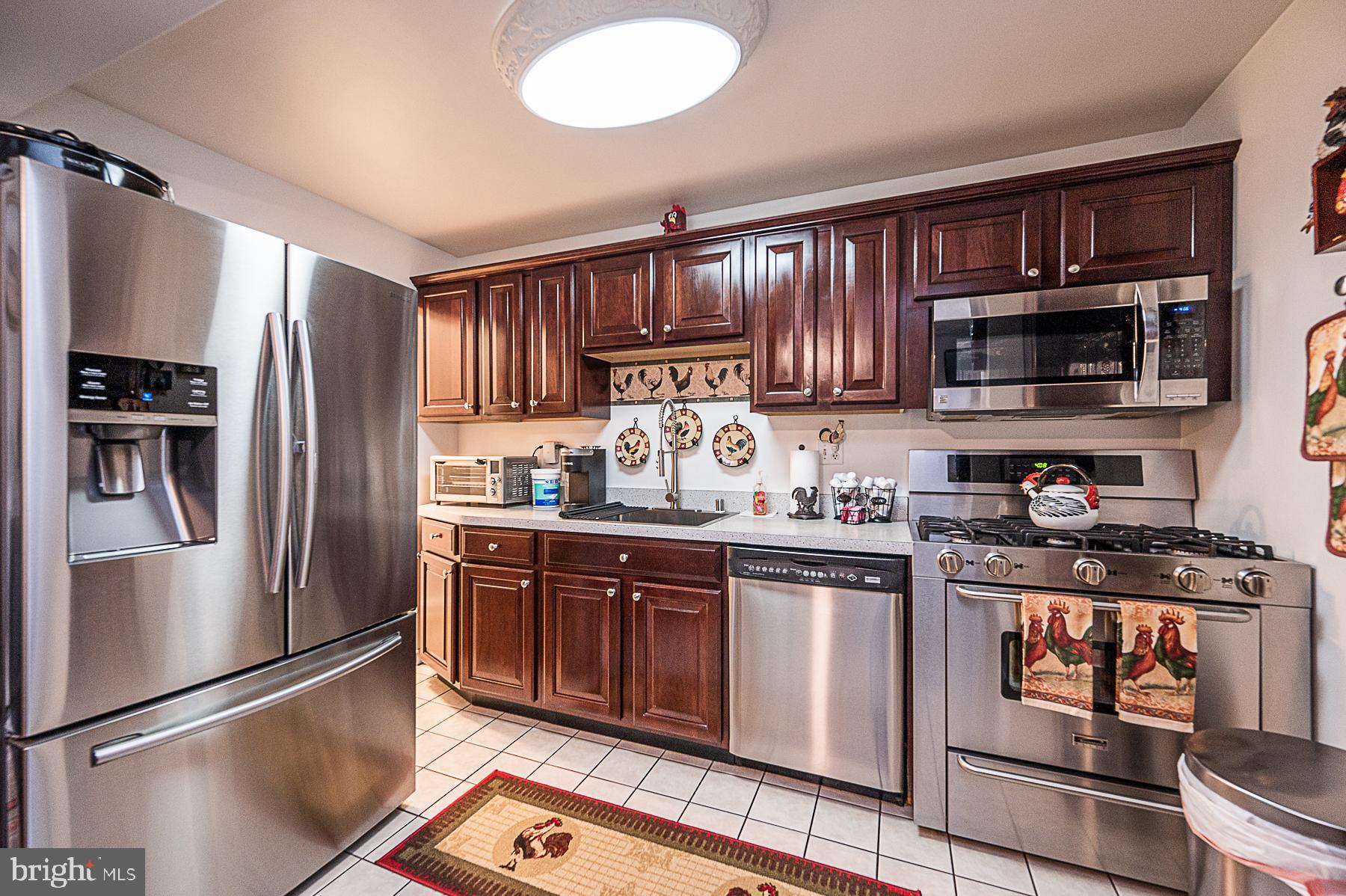 945 Middlesex Road Essex, MD 21221 - Photo 5 of 33 a kitchen with stainless steel appliances granite countertop a refrigerator stove and sink