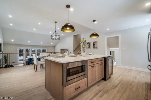 a kitchen with a stove and a wooden floor