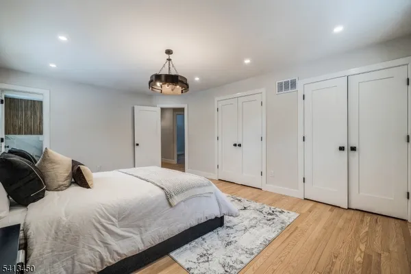 a bedroom with a bed and a chandelier