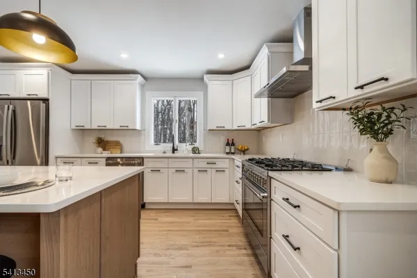 a kitchen with a sink stove and cabinets