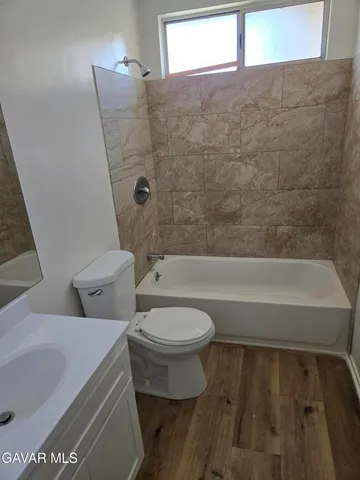 a bathroom with a toilet and a bathtub