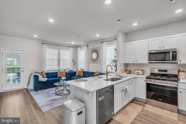 a kitchen that has a sink and a stove top oven