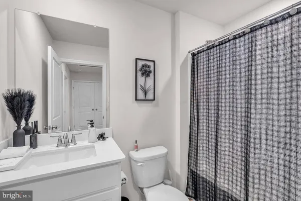 a bathroom with a sink toilet and mirror