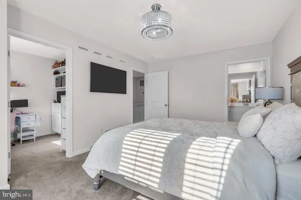 a bedroom with a bed and a television