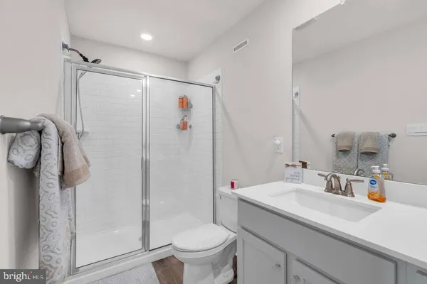 a bathroom with a sink toilet and shower