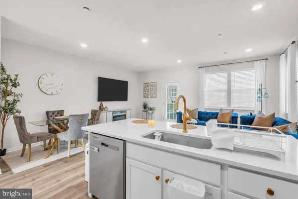 a kitchen with stainless steel appliances sinks a refrigerator and a counter top space