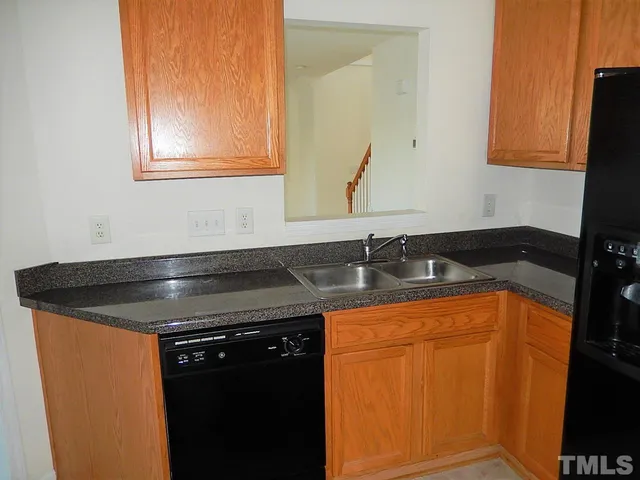 a close view of a sink and cabinets in a bathroom