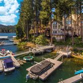 a view of a lake with lawn chairs