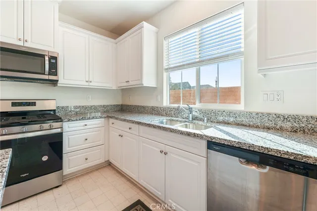 a spacious bathroom with a granite countertop sink and a mirror