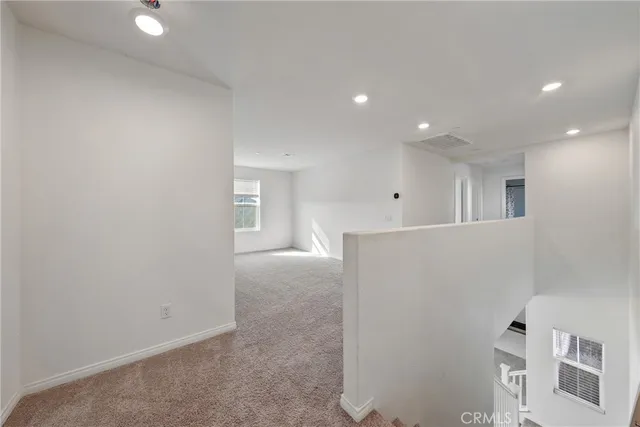 an empty room with windows and closet in a room