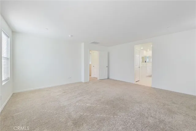 a spacious bathroom with double vanity a mirror a vanity and a shower