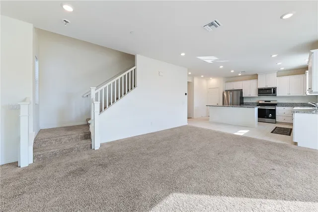 a view of a kitchen with a sink and a stove top oven