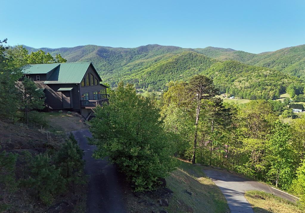 299 Bethabara View Hayesville, NC 28904 - Photo 1 of 131 a view of a lush green hillside and a houses