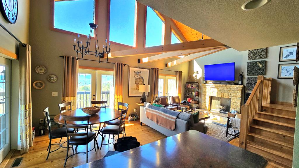 299 Bethabara View Hayesville, NC 28904 - Photo 116 of 131 a living room with furniture a fireplace and large windows