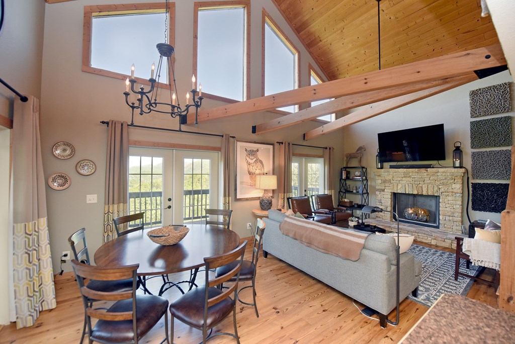 299 Bethabara View Hayesville, NC 28904 - Photo 17 of 131 a living room with furniture a fireplace and a flat screen tv