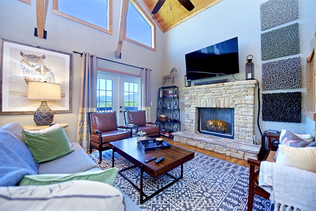 299 Bethabara View Hayesville, NC 28904 - Photo 20 of 131 a living room with furniture a flat screen tv and a fireplace
