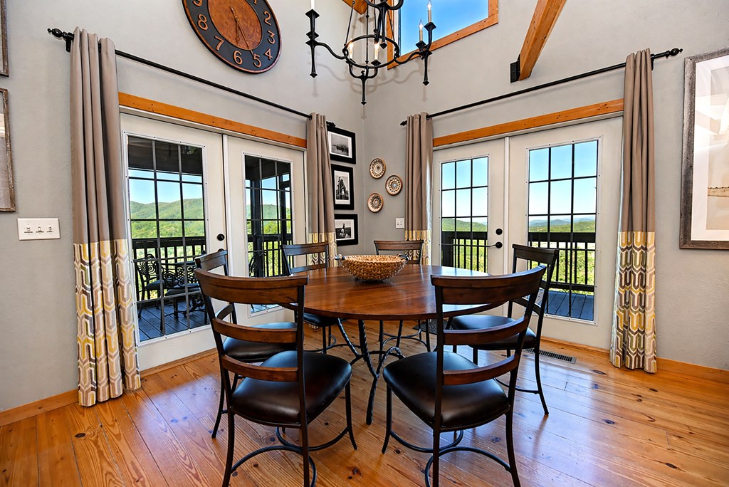 299 Bethabara View Hayesville, NC 28904 - Photo 22 of 131 a dining room with furniture a chandelier and wooden floor