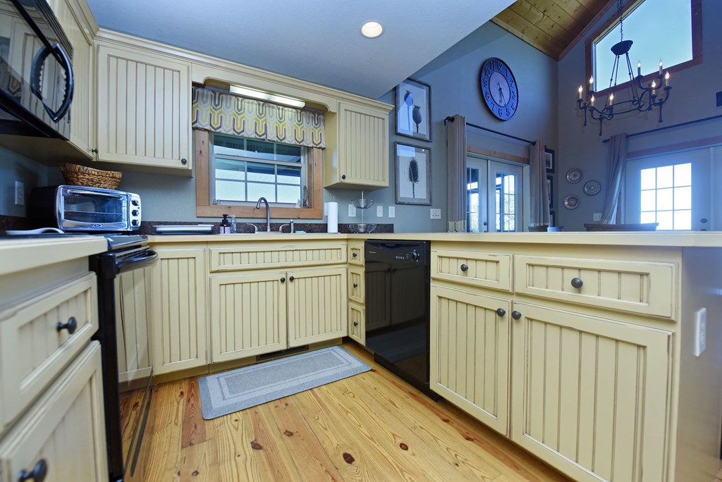 299 Bethabara View Hayesville, NC 28904 - Photo 43 of 131 a kitchen with a sink cabinets and wooden floor
