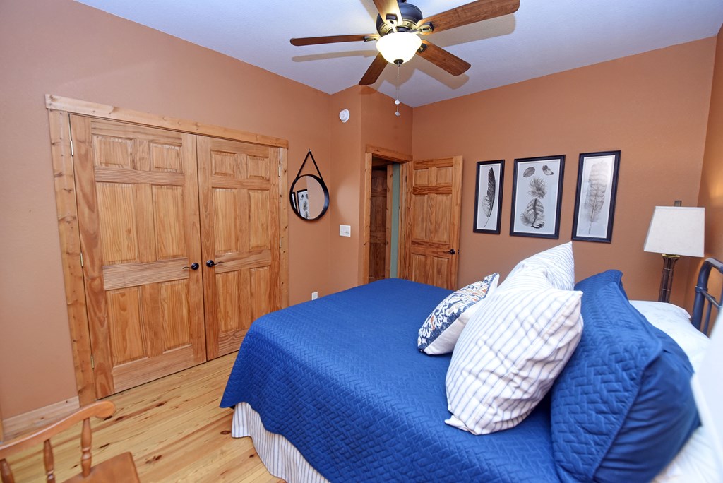 299 Bethabara View Hayesville, NC 28904 - Photo 48 of 131 a bedroom with a bed and a chandelier