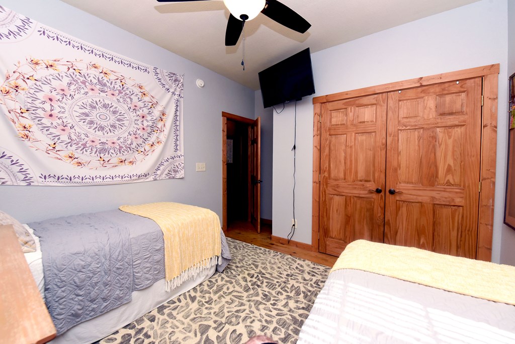 299 Bethabara View Hayesville, NC 28904 - Photo 50 of 131 a bedroom with a bed and a chandelier