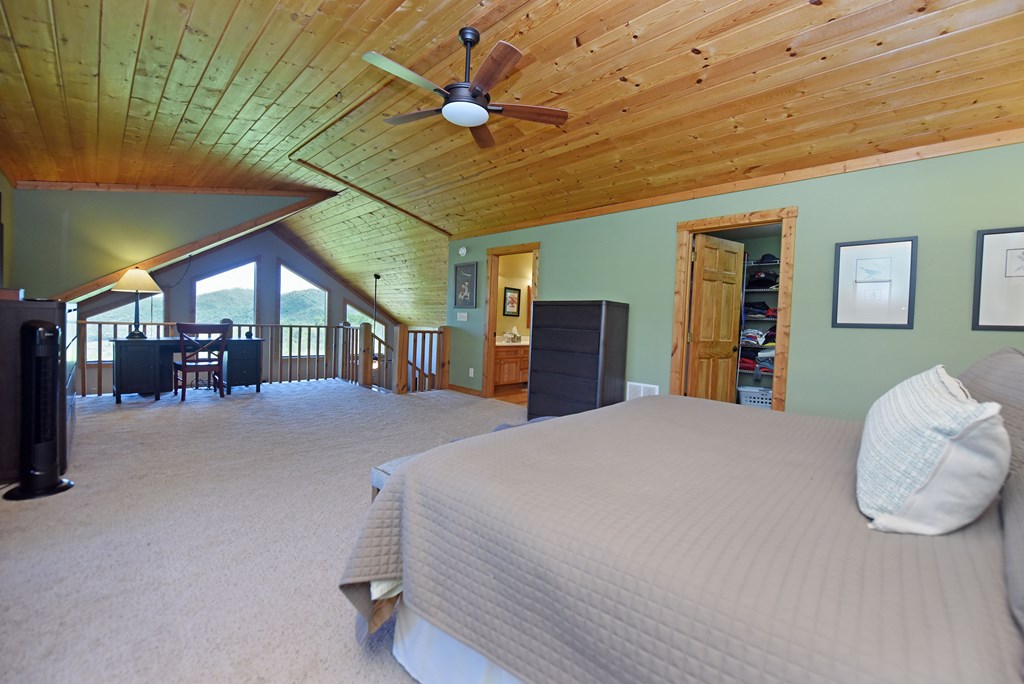 299 Bethabara View Hayesville, NC 28904 - Photo 64 of 131 a bed room with a bed and a chandelier