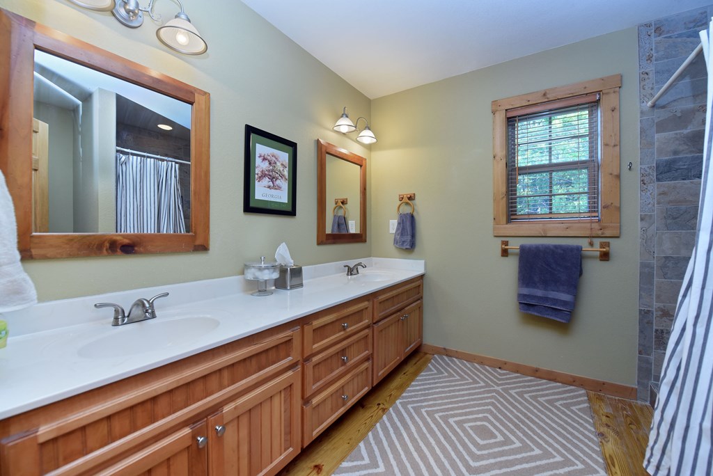 299 Bethabara View Hayesville, NC 28904 - Photo 65 of 131 a bathroom with a double vanity sink and a mirror