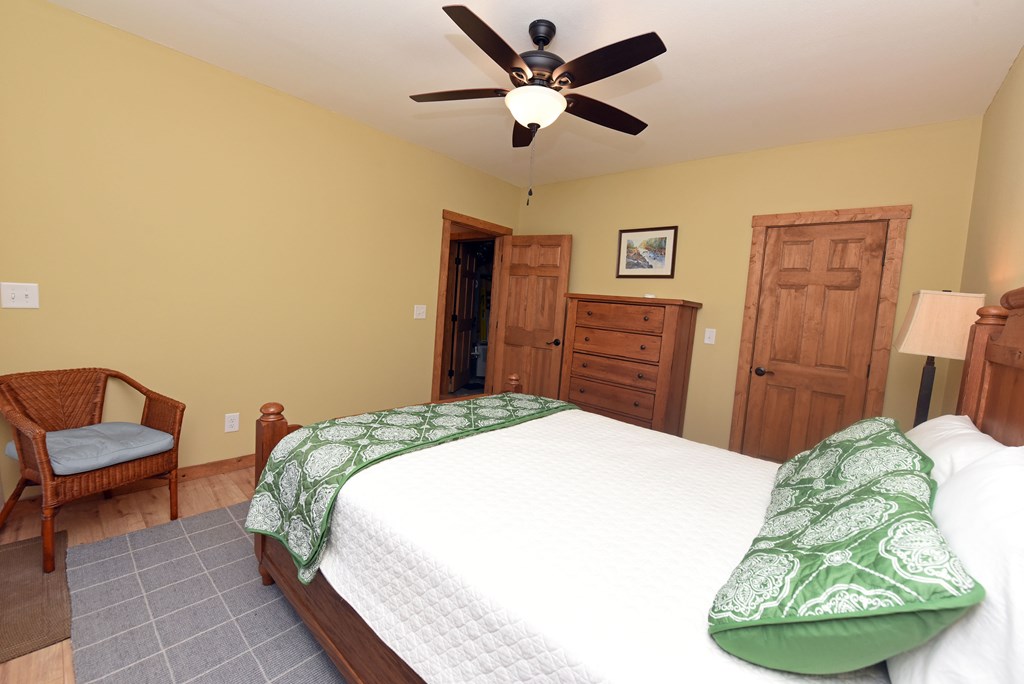 299 Bethabara View Hayesville, NC 28904 - Photo 70 of 131 a bedroom with a bed and dresser with wooden floor